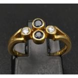 A Vintage 18K Yellow Gold Diamond and Sapphire Ring. Two vertical sapphires and two horizontal