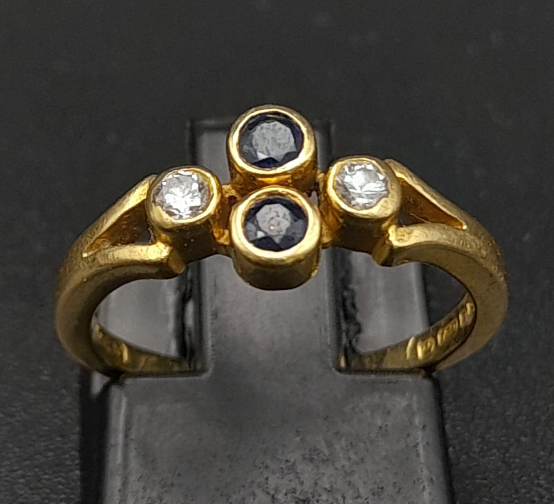 A Vintage 18K Yellow Gold Diamond and Sapphire Ring. Two vertical sapphires and two horizontal
