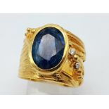 A designer, sterling silver and 18 K yellow gold ring with a large, oval cut natural kyanite.