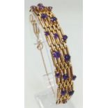 A Vintage 9K Gold and Amethyst Gate Bracelet. Beautifully constructed with 19 clean well faceted