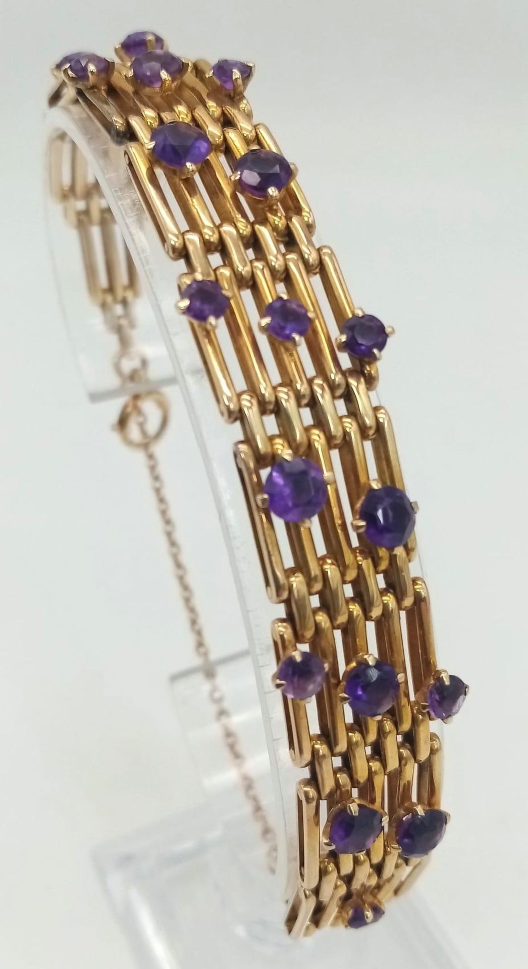 A Vintage 9K Gold and Amethyst Gate Bracelet. Beautifully constructed with 19 clean well faceted