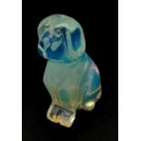 A HAND CARVED FIGURE OF A SITTING DOG MADE FROM A LARGE OPAL . 44.5gms 5cms tall