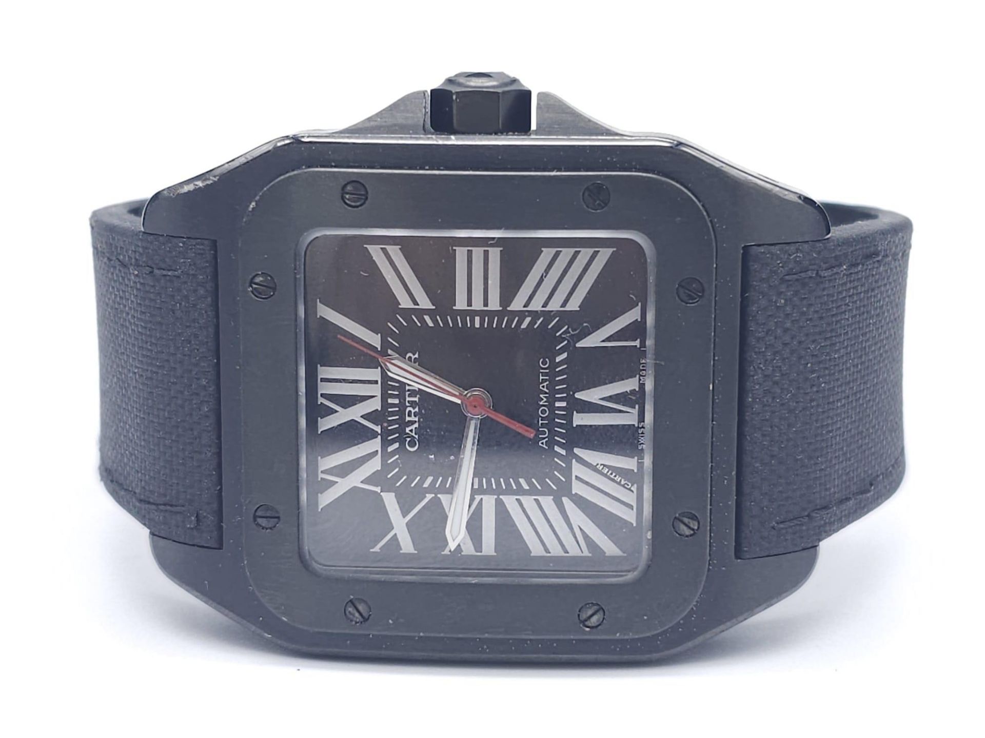 A Stylish Cartier Santos 100 Automatic Gents Watch. Leather and textile strap. Black stainless steel
