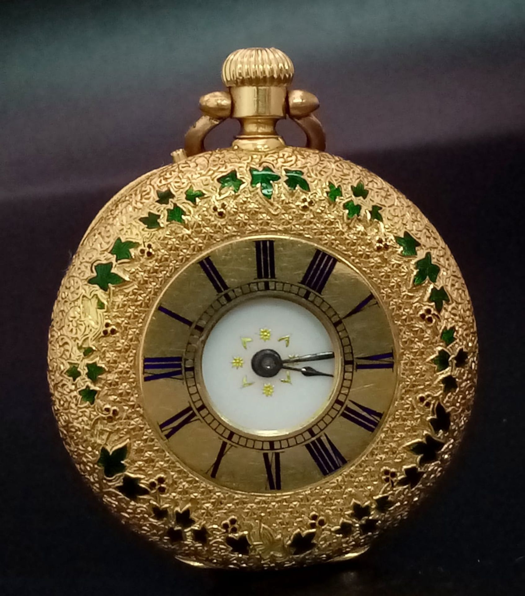 An 18K Gold Half Hunter Pocket Watch with green enamel foilage decoration. 35mm diameter, white dial