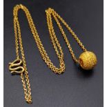 A 21k Yellow Gold Asian Necklace with a 21K Yellow Gold Glitterball Pendant. 46cm necklace length.