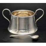 An antique silver sugar bowl plus a silver spoon. Bowl has Full hallmark of Sheffield, sterling