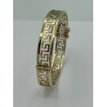 Stunning 9 carat YELLOW GOLD BANGLE in Classic Greek Key Design, having hinged opening with double