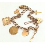 A Vintage 9K Yellow Gold Charm Bracelet with Heart Clasp. Seven charms including, cross and