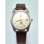 A Vintage Rado Green Horse Gents Watch. Brown leather strap. Silver tone dial with date window.