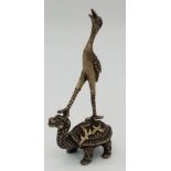 AN ANTIQUE GILDED BRONZE FIGURE OF A CRANE STANDING ON A TORTOISE . 93.2gms 9.5cms tall