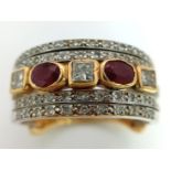 A Statement 18k Yellow, White Gold and Gemstone Band Ring. A Central reservation of oval rubies