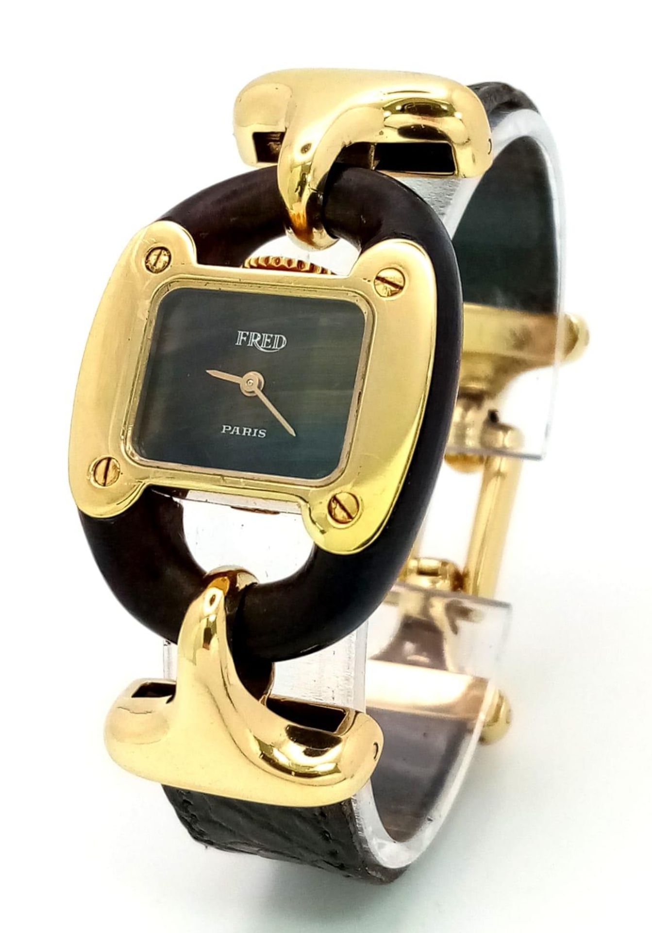 A very rare Fred of Paris 18K Gold Ladies Watch. Black leather and gilded metal bracelet. 18k gold