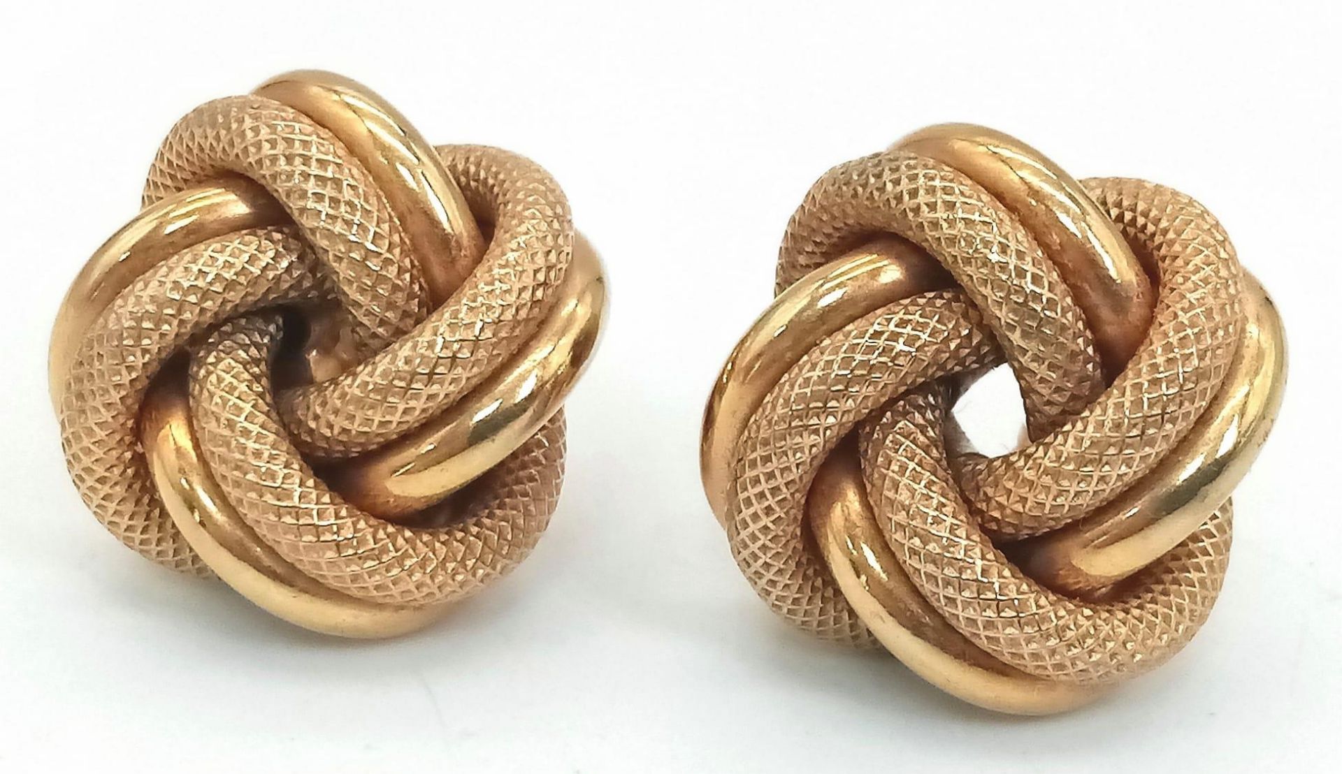 A Pair of 9K Yellow Gold Knot Earrings. Smooth and geometric patterns entwined. 4.95g total weight.