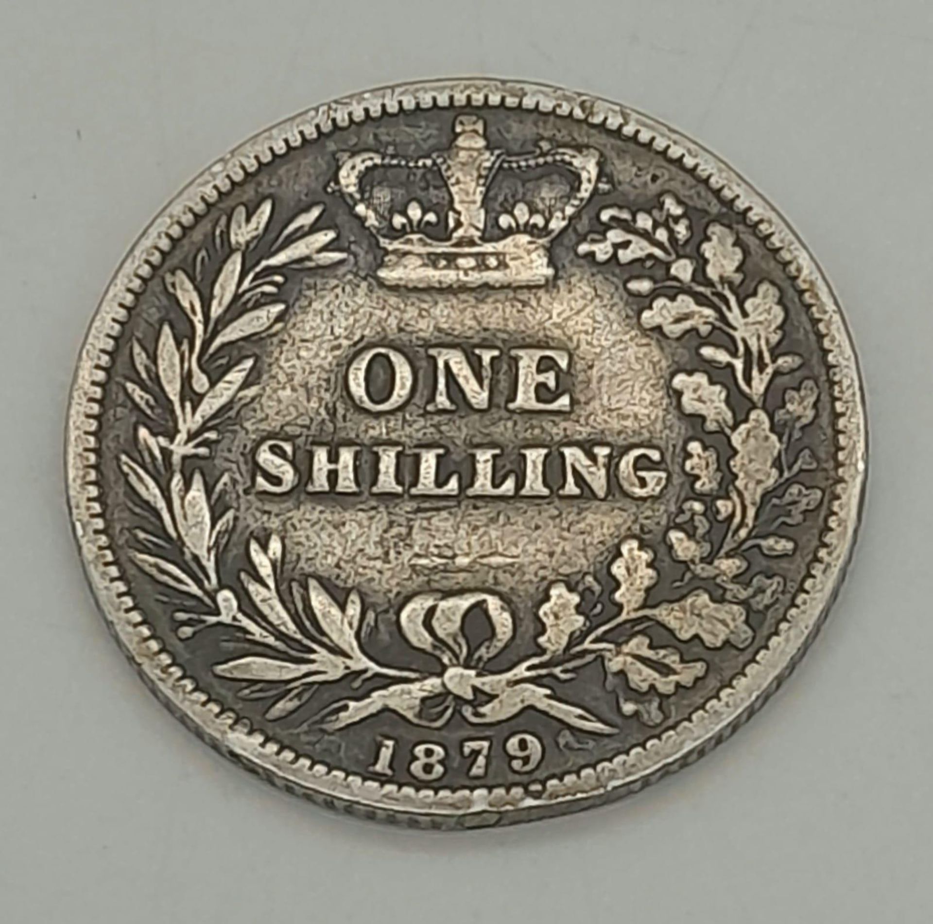 An 1879 Queen Victoria Silver Shilling. Please see photos for conditions.