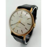 A Beautiful Vintage 9K Gold Omega Geneve Gents Watch. Black leather strap. 9K gold case - 34mm.