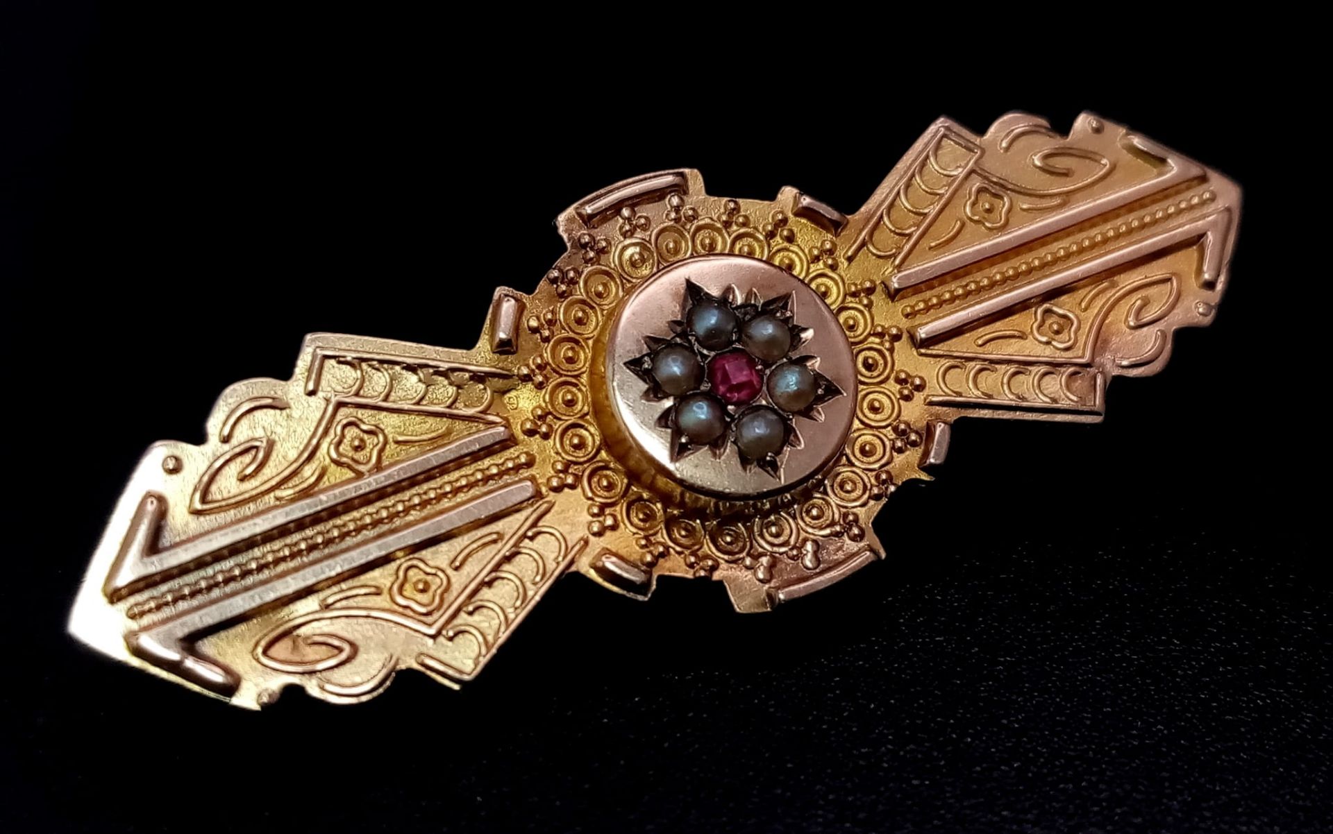 A Beautifully Decorated Antique 9K Yellow Gold Seed Pearl and Ruby Brooch. 4cm. 2.52g total weight.