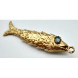 A Vintage 9k Yellow Gold Articulated Fish Pendant/Charm with Aquamarine Eyes. 4cm. 3.11g weight.