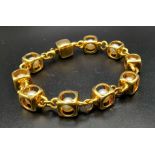 A Designer (Gio Caroli) 18K Yellow Gold and Pearl Bracelet. Nine beautiful South Sea pearls - each