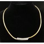 An 18K Yellow Gold and Diamond Choker Necklace. Rich yellow gold gives way to ten quality round