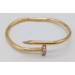 A 18K YELLOW GOLD 0.45CT DIAMOND SET CARTIER STYLE NAIL BANGLE. TOTAL WEIGHT 34.34G. THE WIDEST