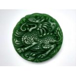 A Large Circular Chinese Green Jade Dragon Pendant or Paperweight. 46mm diameter.