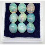 Nine, top grade, Australian, oval cabochon, OPAL stones, with excellent iridescent hues. Dimensions: