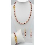 A very attractive, pink pearl and faceted ruby necklace, bracelet and earrings set with PANTHER