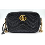 A Black GUCCI GG Marmont Matelasse Mini Leather Crossbody bag. Come with gold-tone hardware and