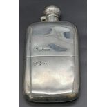 An antique sterling silver travel hip flask with a removable lower part to be used as a cup.