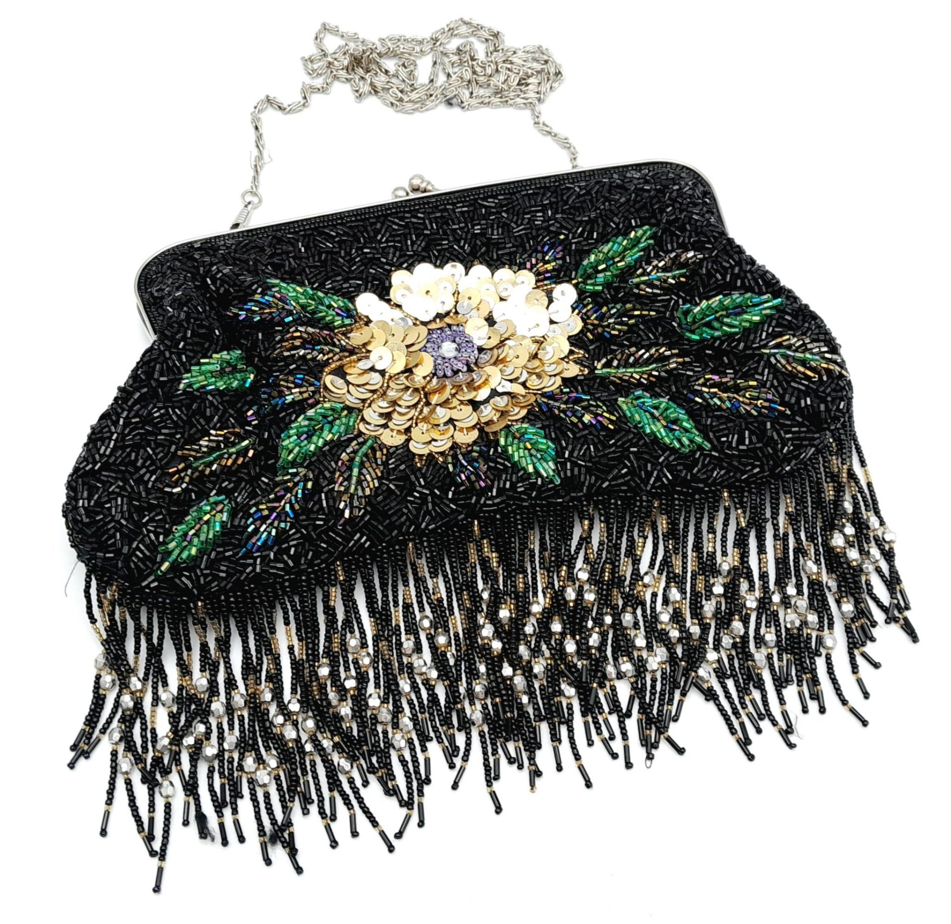 A Fashionable Floral Beaded Bag. Sequins and tassels decoration. Silver tone shoulder chain. 23cm