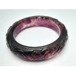 A rare, vintage, amethyst coloured PEKING GLASS bangle with carved hunting scene of dogs and