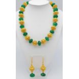 A very regal necklace and earrings set with round cabochon emeralds and gold filled, intricate large