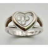 An 18K White Gold Chopard Happy Diamond Ring. Heart shaped with three floating diamonds - 0.17ct.