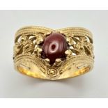 A Beautiful Vintage 9K Yellow Gold and Garnet Regal Style Ring. Pierced chevron decoration. Size