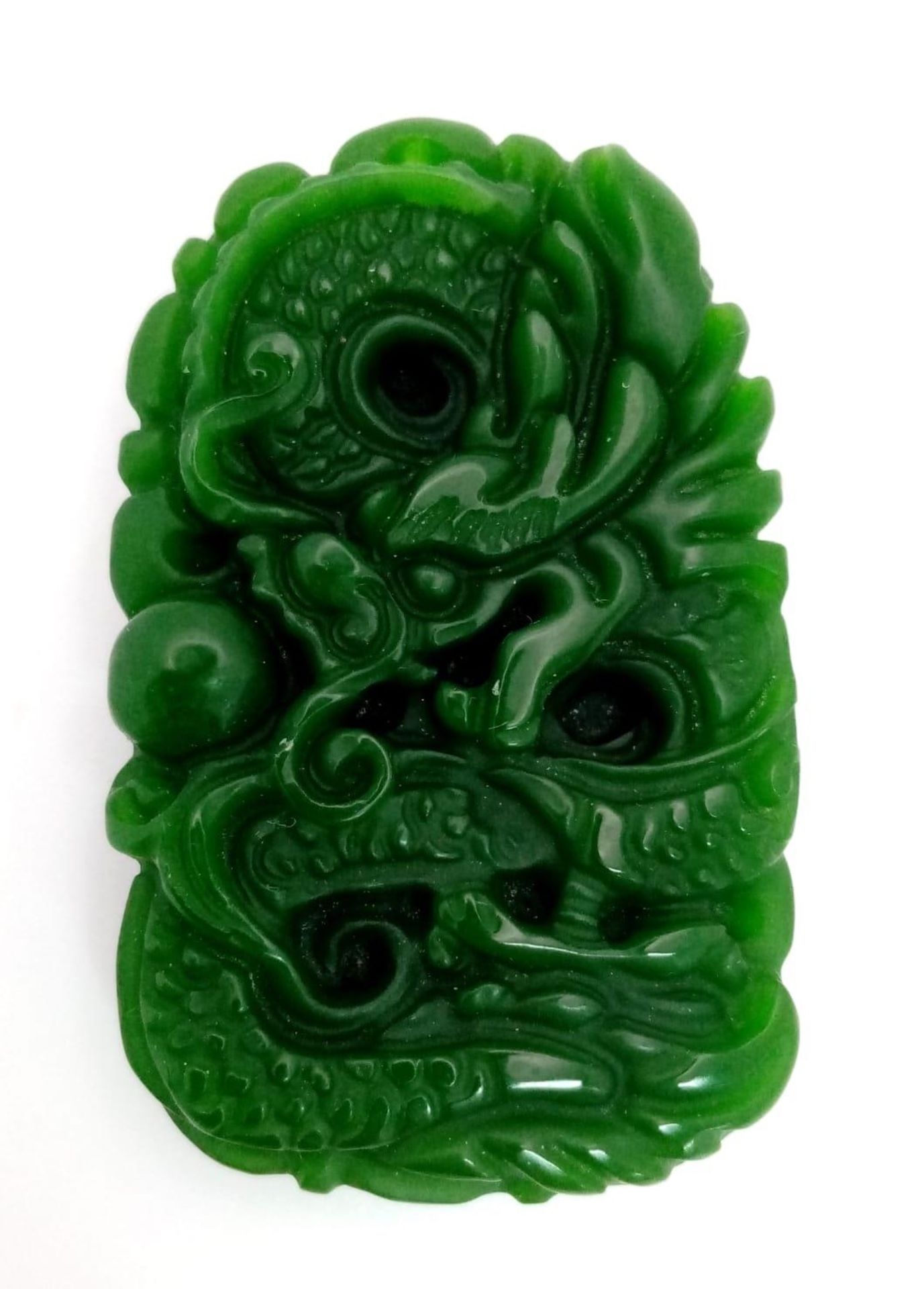 A Chinese Green Jade Dragon Pendant. 5cm.