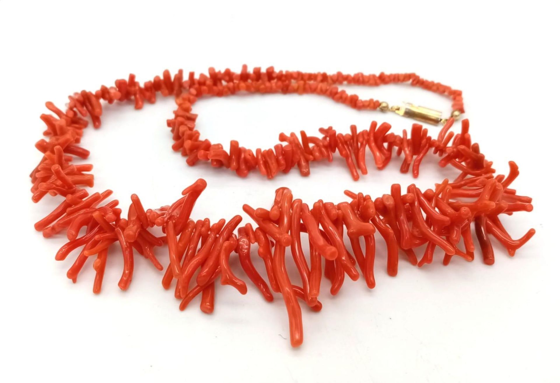 A Natural coral necklace with gold clasp. Total length 56cm.