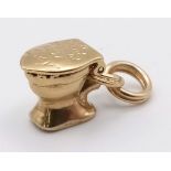 A VINTAGE 9K YELLOW GOLD TOILET CHARM WITH OPENING LID ENGRAVED WITH THE WORDS LIFER WASN'T MEANT TO