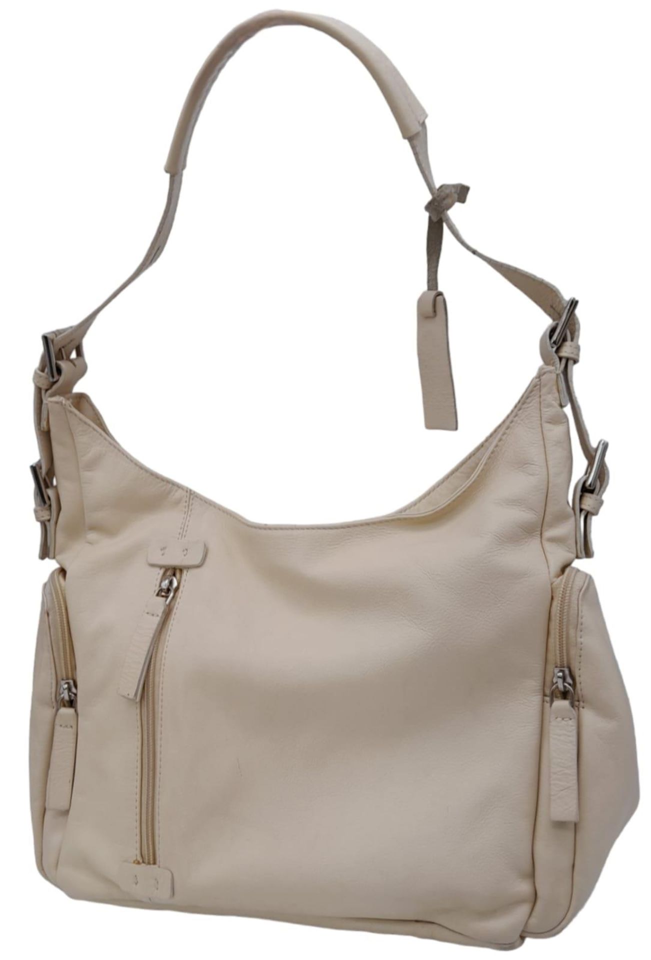 An Azure Beige Leather Handbag. Beige leather exterior with three zipped compartments. Purple