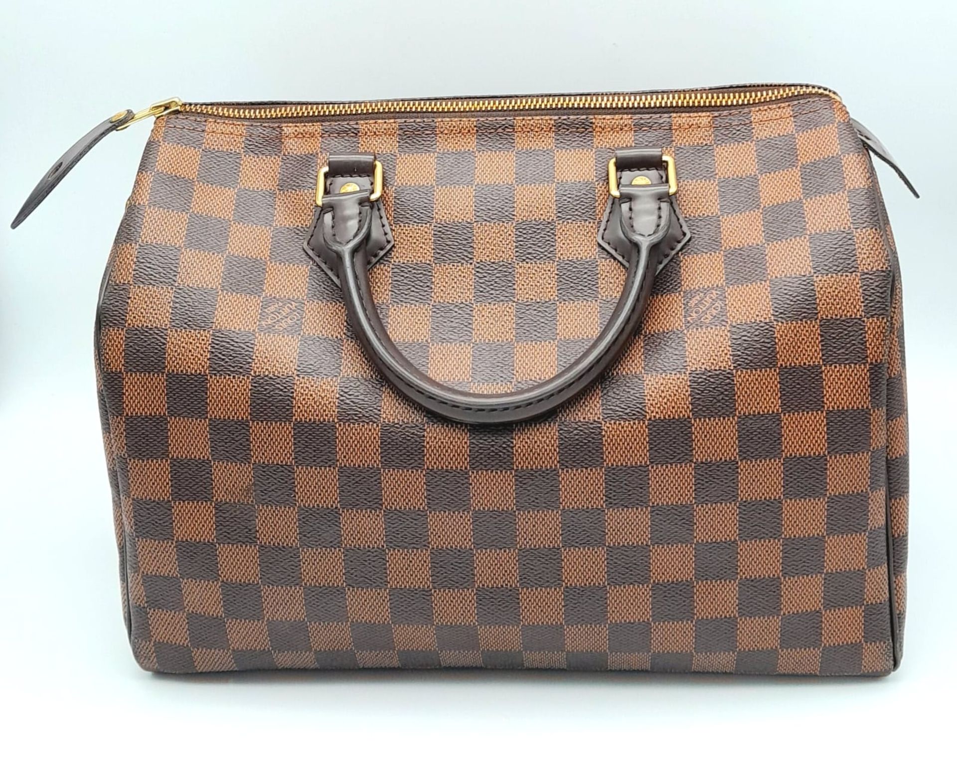 A Louis Vuitton Speedy 30 ebony damier canvas Handbag. Accessories to include padlock and key.