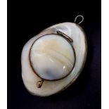 A rare, antique, probably Victorian, pill box pendant made of mother of pearl and silver.