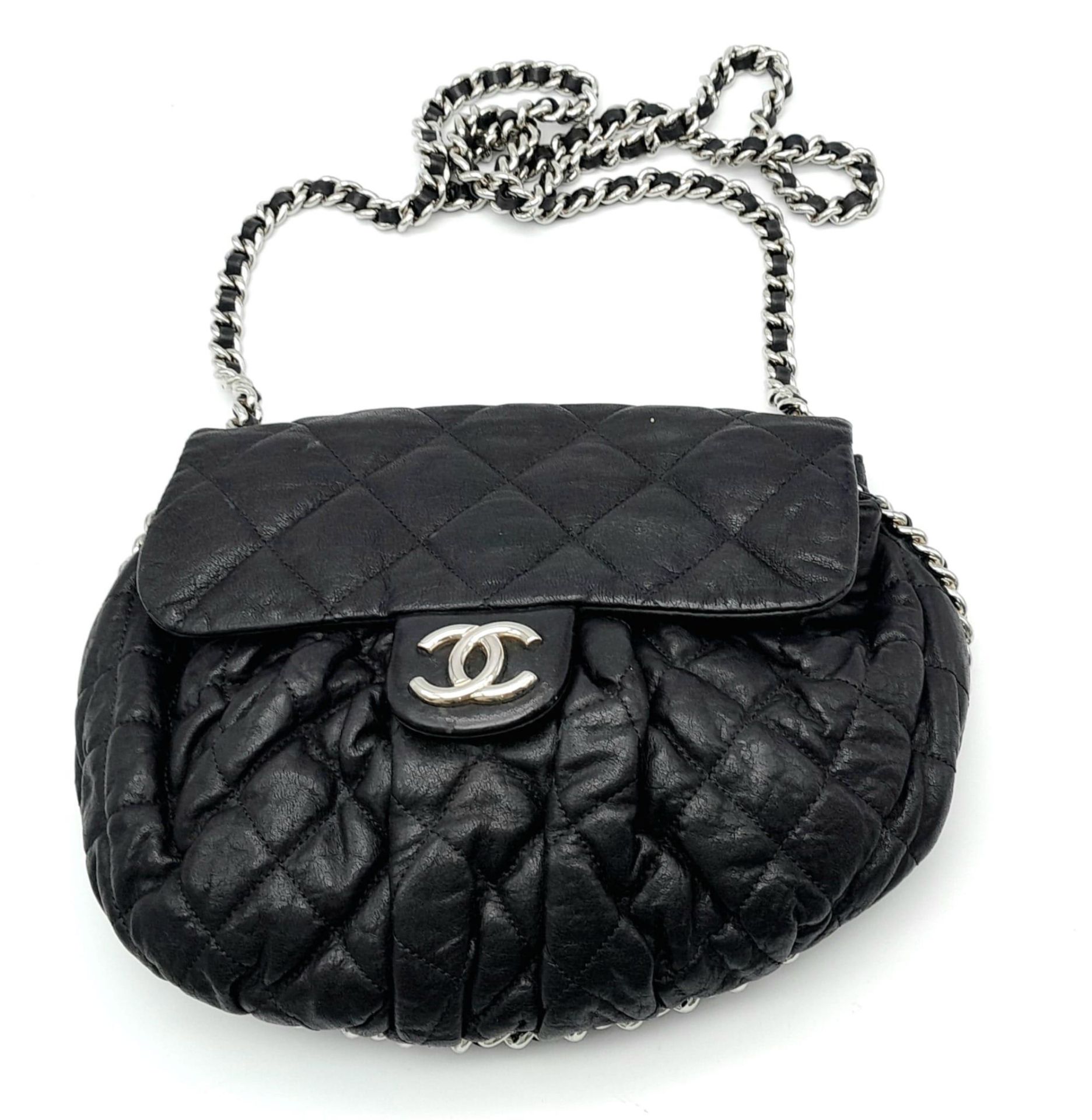 A Black Chanel Quilted Leather CC Shoulder Bag with Flap Chain surrounding it. One main