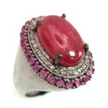 An 11.45cts Cabochon Ruby Ring with .45ct Diamond and 1.25ct Ruby halos. Set in 925 silver. Size