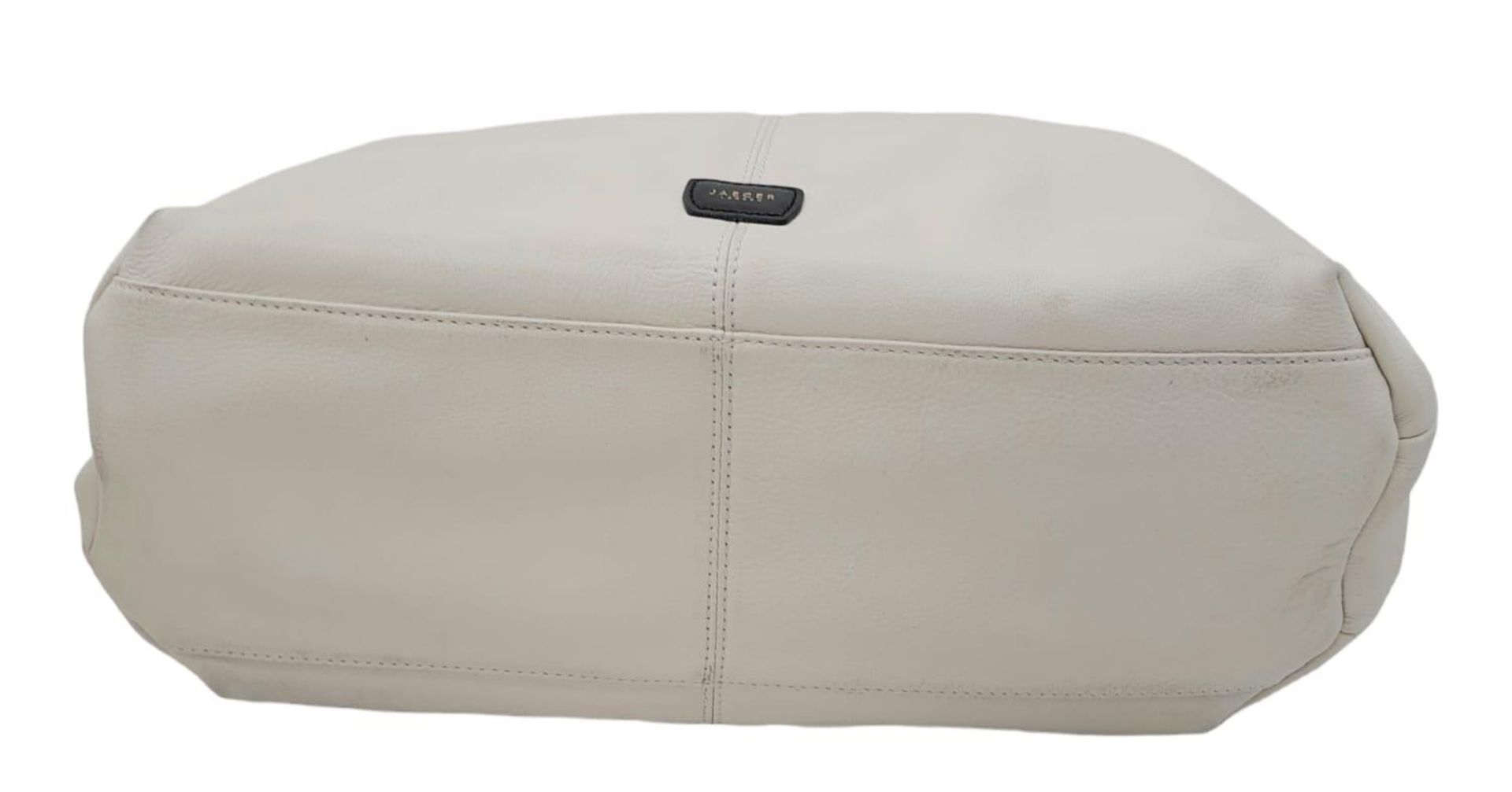 A Jaeger White Leather Handbag. White leather exterior with black leather belt closure and - Image 5 of 8