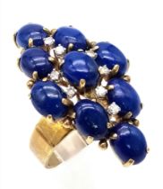 A DESIGNER 18K GOLD RING WITH LAPIS LAZULI AND DIAMONDS . 10.4gms