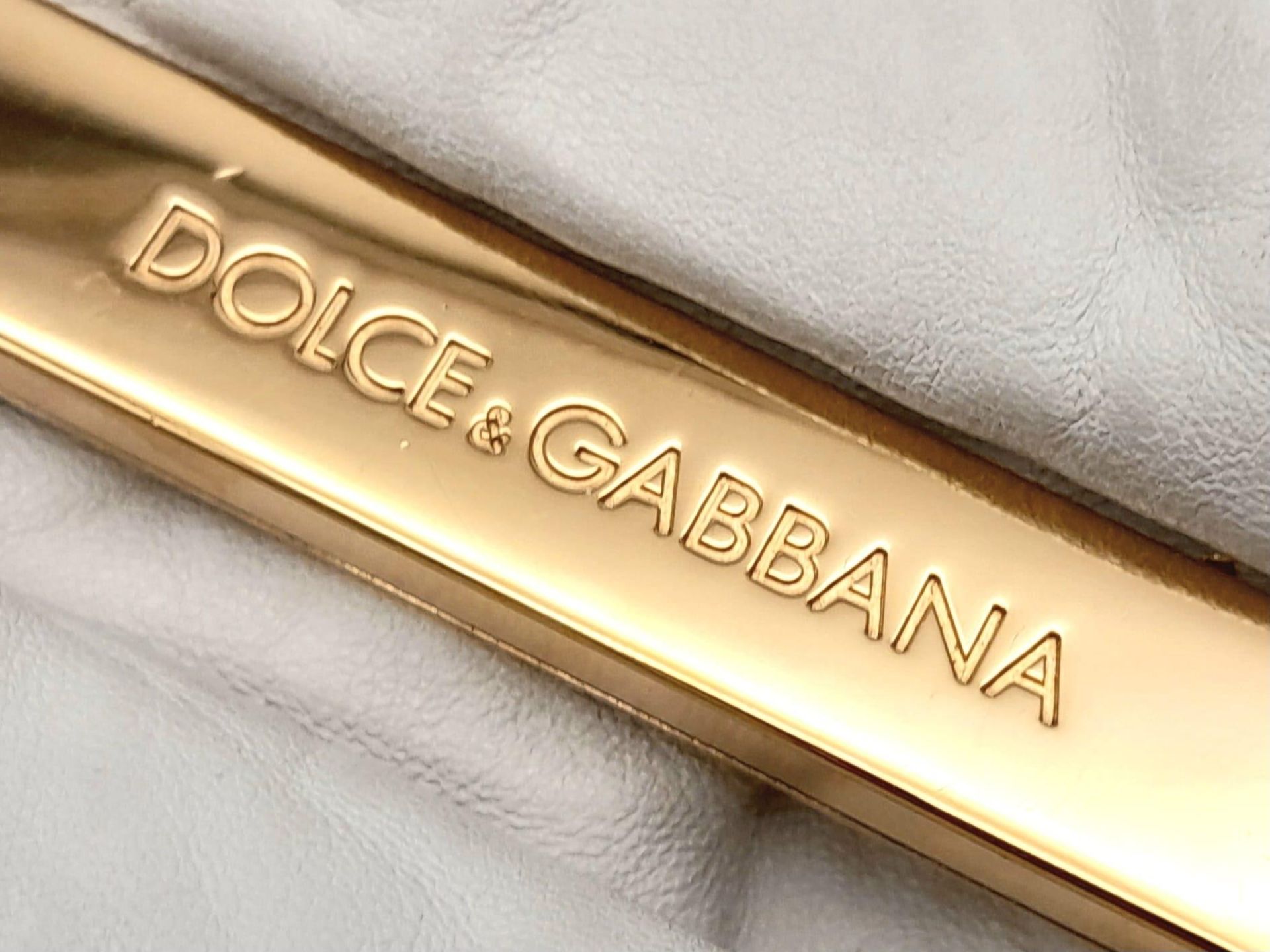 A Dolce and Gabbana Vintage Anniversary Handbag. White leather exterior with twin pockets. Gold tone - Image 8 of 10