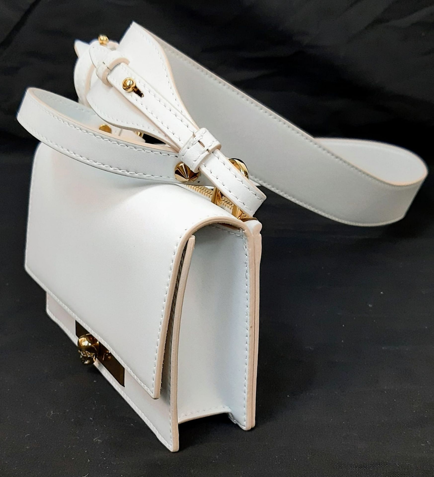 An Alexander McQueen Deep Ivory Leather Clutch Bag with Gold Skull Detail. Beige Suede Interior, - Image 3 of 9