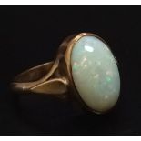 A Vintage 9K Yellow Gold Opal Ring. A lovely colour-play oval opal. 2.6g total weight. Size I.