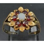 A Vintage 9K Yellow Gold Garnet and Pearl Ring. Central pearl with a halo of garnets. Size N. 2.