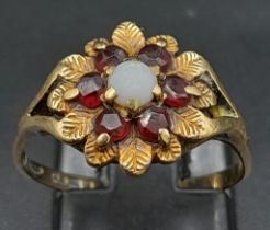 A Vintage 9K Yellow Gold Garnet and Pearl Ring. Central pearl with a halo of garnets. Size N. 2.