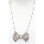 An elegant and sophisticated starling silver chain necklace with a bow pendant loaded with